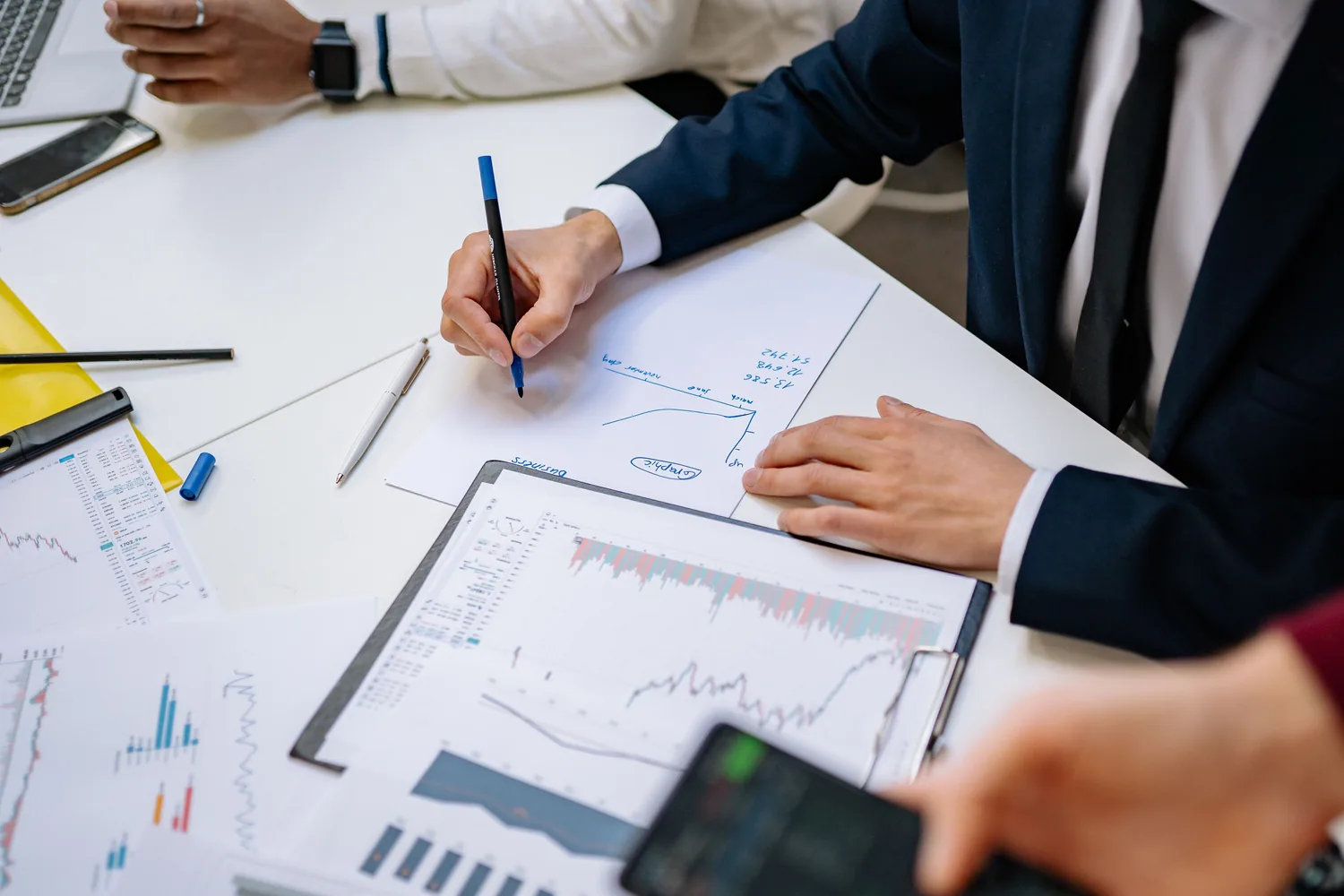 Advisors reviewing financial charts during a planning session